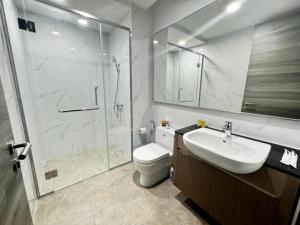 a bathroom with a shower and a toilet and a sink at Agile Premier Suites KL in Kuala Lumpur +51 photos