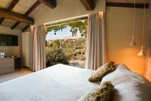 A bed or beds in a room at Tenuta San Masseo - boutique farm resort & SPA