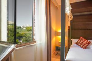 A bed or beds in a room at Tenuta San Masseo - boutique farm resort & SPA