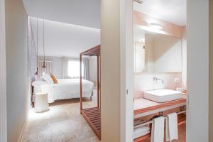 A bed or beds in a room at Tenuta San Masseo - boutique farm resort & SPA