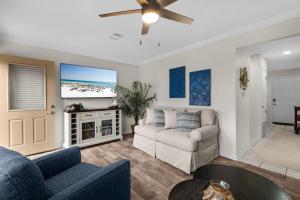 a living room with a couch and a tv at Beach Rendezvous in Navarre