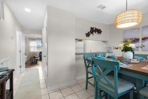 a kitchen and dining room with a table and chairs at Beach Rendezvous in Navarre