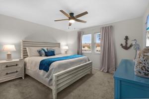 a bedroom with a bed and a ceiling fan at Beach Rendezvous in Navarre +46 photos