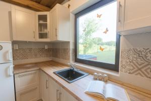 a kitchen with a sink and a window at Nowhere Villa in Nyírmihálydi