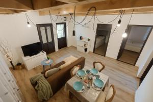 a living room with a couch and a table at Nowhere Villa in Nyírmihálydi