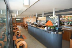 a restaurant with a counter and chairs and a bar at Albergo Celeste in Sestri Levante