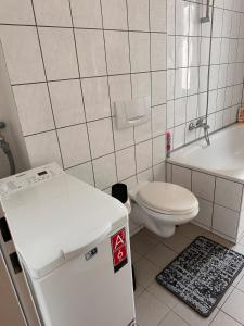 a small bathroom with a toilet and a sink at Apartment on Elbe bike path in Magdeburg +9 photos