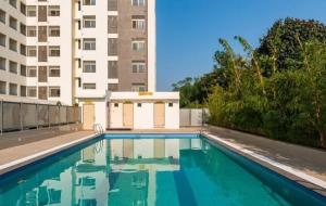 a large swimming pool in front of a building at Stay comfort at City Heart 2Bhk AC ,WIFI & Much more in Indore +9 photos