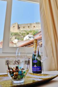 a bottle of wine and a bowl of fish at Scilla Luxury Rooms in Scilla +69 photos