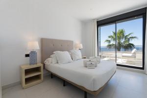 a bedroom with a bed with a view of the beach at Estepona Holiday Hills in Estepona +164 photos
