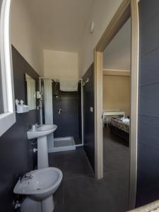a bathroom with a sink and a toilet and a shower at B&B Roseal in Brusciano