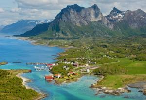 an island in a body of water with a mountain at Koselig campingvogn in Bodø