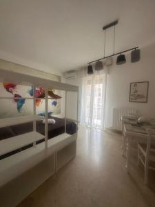 a white room with a bed and a table at MERAVIGLIOSO in Polignano a Mare