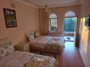A bed or beds in a room at Akar Hotel