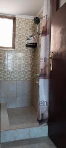 a bathroom with a shower with a shower curtain at Peaceful Seaside Apartments in Vaia +21 photos