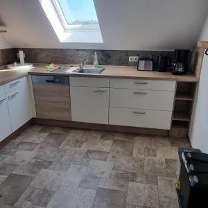 a kitchen with a sink and a window at Ferienwohnung zur Schmiede in Prödel +8 photos