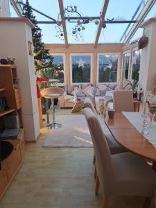 a room with a table and chairs in a conservatory at Beates Daham in Fohnsdorf