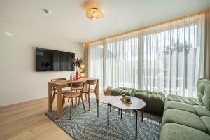 a living room with a couch and a table at Dunique in Palanga