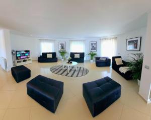 a large living room with couches and a table at Villa Portugal in Palmela