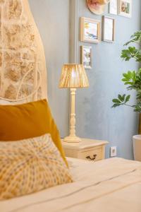 a lamp sitting on a night stand next to a bed at Newly Renovated Romantic Apartment - Primavera Deluxe Rovinj in Rovinj +16 photos
