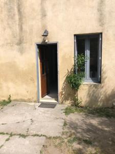 a door to a building with a bird on top of it at La maison de jeanne in Vauvert