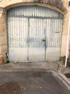 a large metal garage door in a building at La maison de jeanne in Vauvert