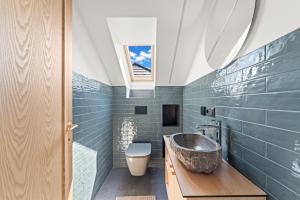 a bathroom with a sink and a toilet at Dunique in Palanga +42 photos