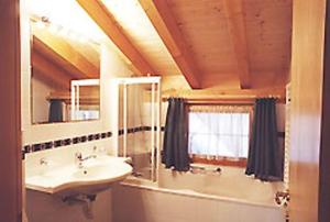 a bathroom with a sink and a mirror at Appartements Gabriele in Samnaun