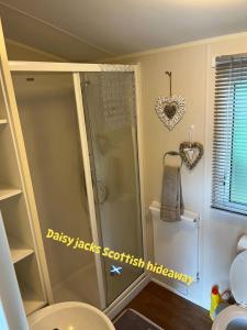 a bathroom with a shower and a toilet in a room at Daisy-Jacks Hideaway in Briery Yards +16 photos