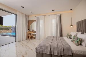 a bedroom with a bed and a view of a patio at Boheme Villas close access to Laganas Resort in Zakynthos Town +62 photos