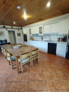 a large kitchen with a wooden table and chairs at Wellpark House, Family Mansion in Oughterard