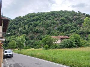 a car parked on the side of a road with a mountain at alloggio Valsusa in Vaie +2 photos
