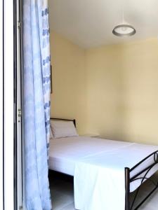 a bedroom with a bed and a window at Sokrates Apartments in Preveza