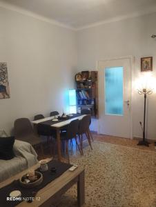 a living room with a table and chairs and a dining room at John's House in Chalkida