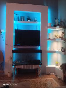 a living room with a television with blue lights at John's House in Chalkida