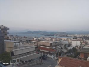 a city with buildings and a body of water at John's House in Chalkida
