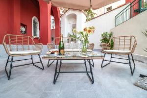 a patio with two chairs and a table with a bottle at Dimora Gioia in Ercolano