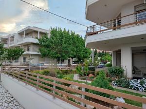 a house with a fence in front of a garden at Alexandra Boutique Residence VILLAS in Alexandroupoli