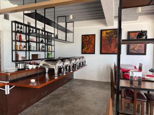 a restaurant with a bar with a table and chairs at SOLA Guesthouse in Dumaguete
