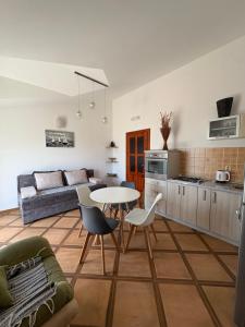a kitchen and a living room with a table and chairs at Apartments Ćuković in Risan