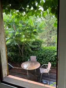 a table and two chairs sitting on a porch at studio en provence verte in Le Val +3 photos