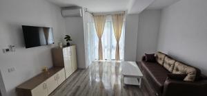 a living room with a couch and a large window at Vera Home 3 in Râmnicu Vâlcea