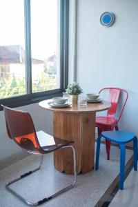 a table and two chairs and a table and a chair at Navee Studio Apartments Canggu in Munggu