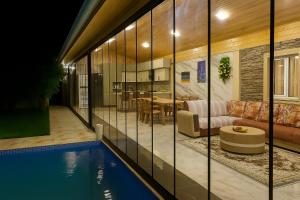 a house with a swimming pool and a living room at Shabran Pearl Oasis - Family Garden House - Ailəvi Bağ Evi in Surra