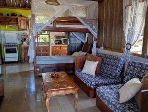 a living room with a couch and a table at Gite Maeva in Djamandjary