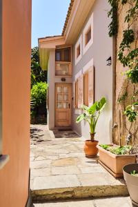 a door of a house with a potted plant at D BERNARDAKI Garden House in Mytilini