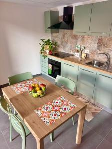 - une cuisine avec une table en bois et un bol de fruits dans l'établissement La casetta di Lu' Loft con 1 camera da letto, à Fasano