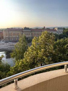a view of a city with a river and buildings at DarViva Apartment Niš, center, private garage parking, river view in Niš