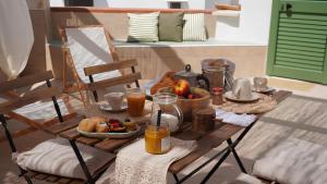 a table with breakfast foods and drinks on it at B&B Casa Uliva in Castellaneta