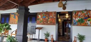 a room with paintings on the walls of a building at Chithrapuri Heritage Hotels Pvt Ltd in Alattūr